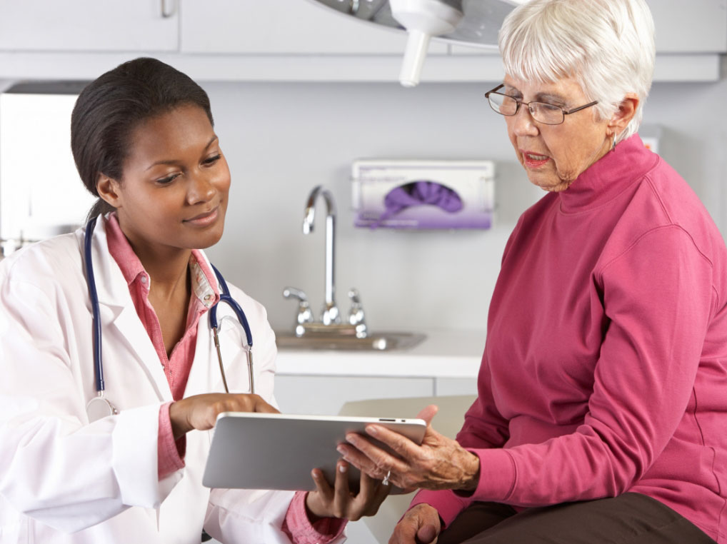 doctor-and-patient Female doc showing a patient chart to an elderly female