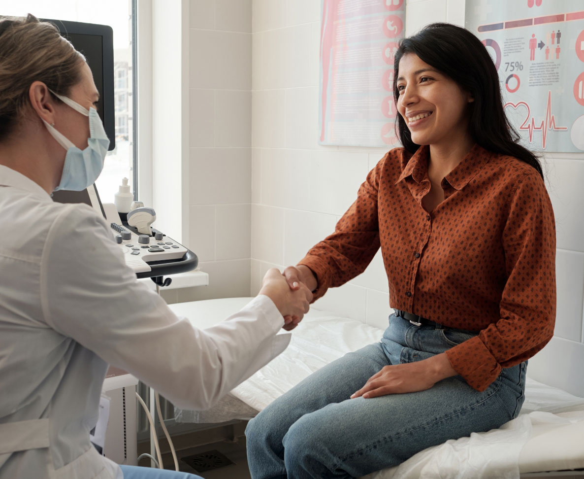 doctor-and-woman-patient Masked doctor shaking hands with female patient