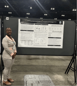Lilian Okoye standing in front of her poster