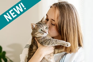 A blonde woman cuddling a tabby cat in a photo promoting TriCore's new direct order Cat Allergy Test panel.
